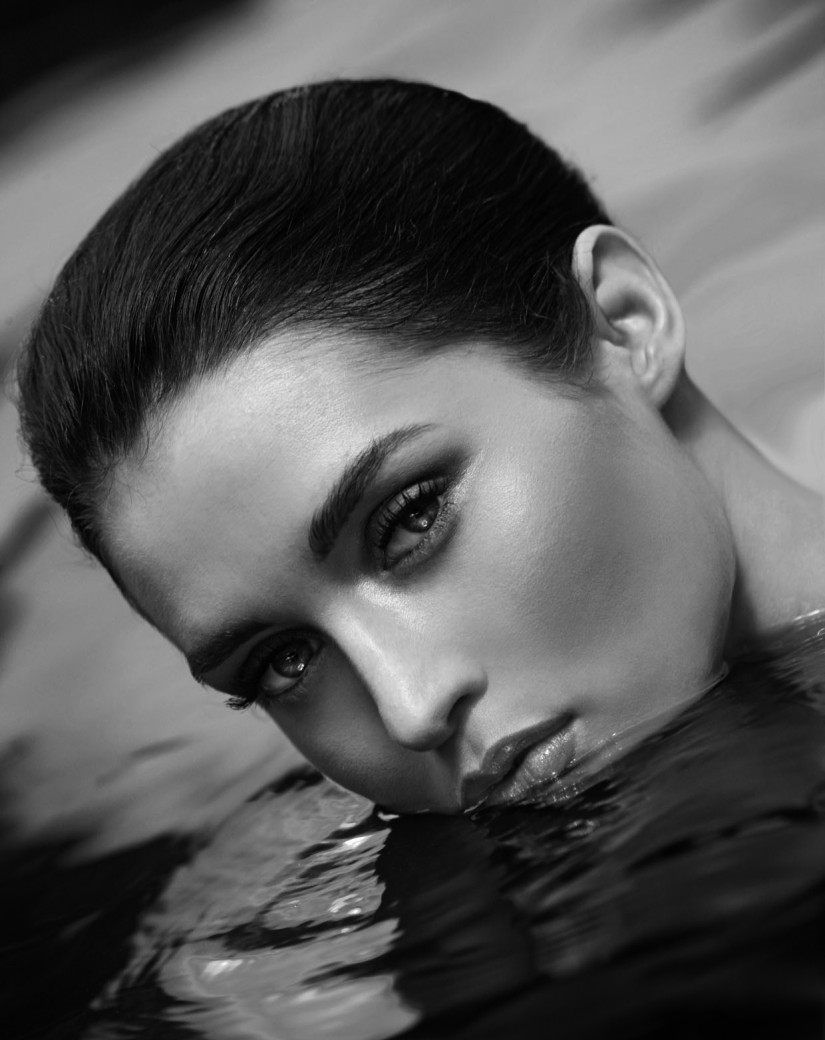 Schwarz-Weiß-Fotografie einer Frau mit kurzen Haarem im Wasser